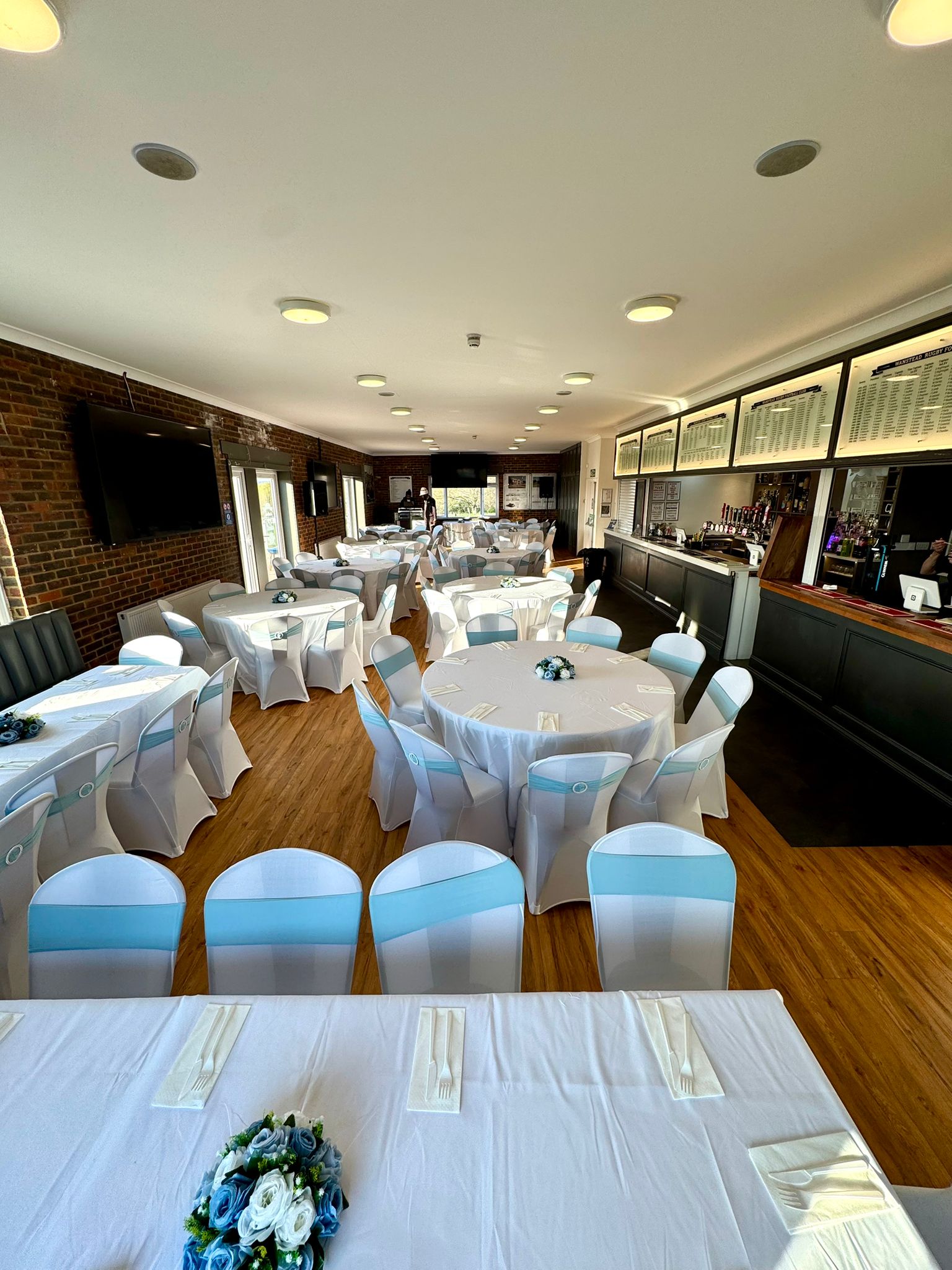 Spacious view of the function room layout with multiple banquet tables